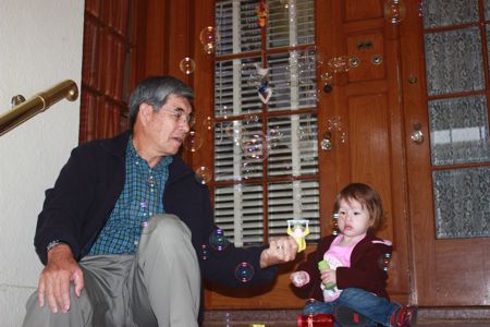 Grandpa Cal shows Maile the bubble gun...