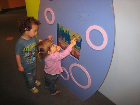 Hey taller and slightly older little boy, let me show you how this works - it's just like my iPad, except stuck on the wall, so I bet you just need to touch the animals and they will do stuff...