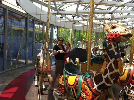 Maile was not as enthusiastic about the merry-go-round. Here Chris is negotiating with her to ride one of the horses...