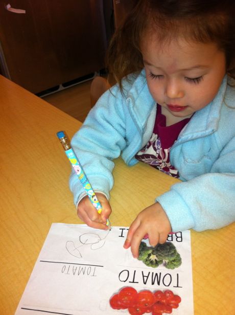 Maile can't decide whether she wants to eat the broccoli or spell it!