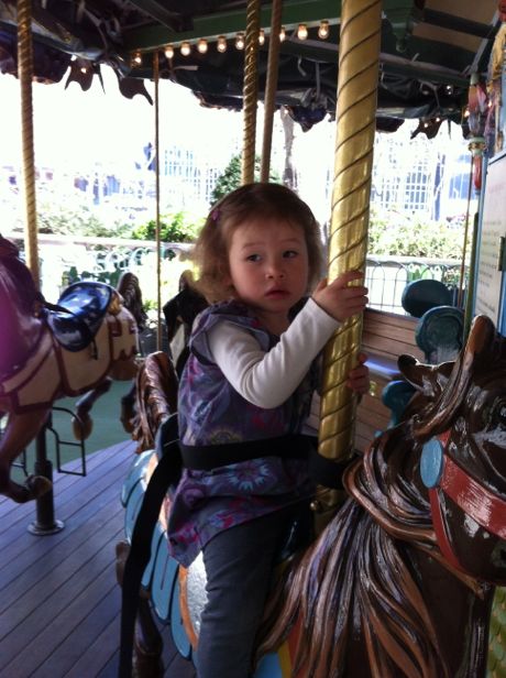 Maile on the carousel with Grandma Jill (2012)