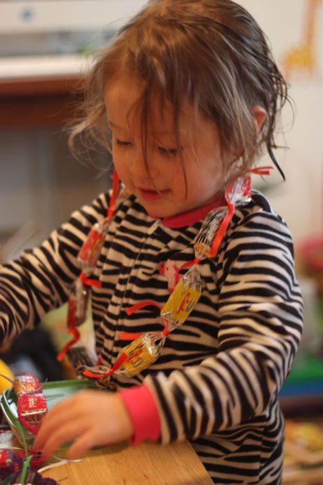 Maile Girl putting together the chocolate leis...