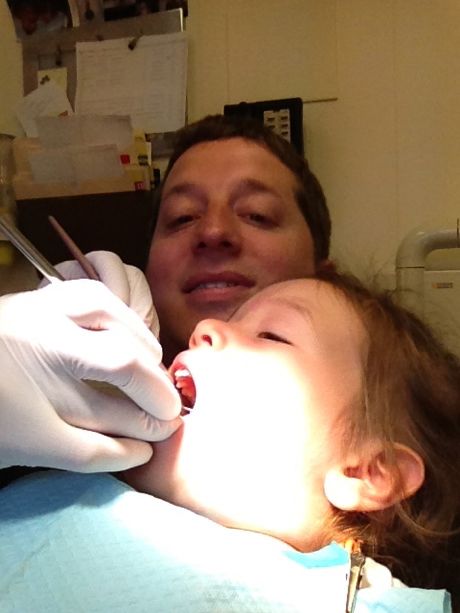 Up close and personal with Maile Girl getting her teeth cleaned (she's sitting on Daddy's lap)