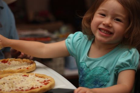 Saying cheese next to some cheese pizza :)