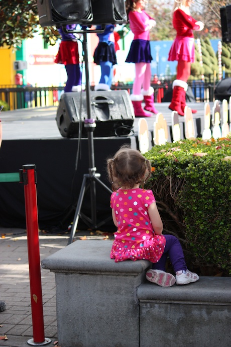 We were walking by this stage show with 4 singer/dancers and Maile just walked over and plopped herself down on this ledge. She proceeded to watch the next 15 minutes of the show completely enthralled.