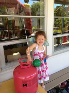 Helping with setup by blowing up some balloons - considered teaching Maile the magic of helium, but held myself back this year...