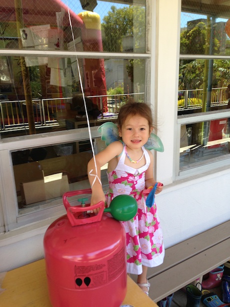 Helping with setup by blowing up some balloons - considered teaching Maile the magic of helium, but held myself back this year...