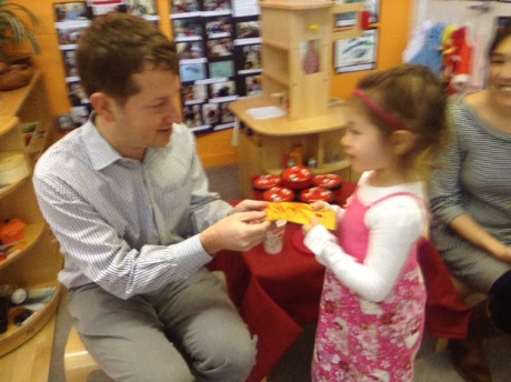 Daddy giving Maile her New Year's envelope...