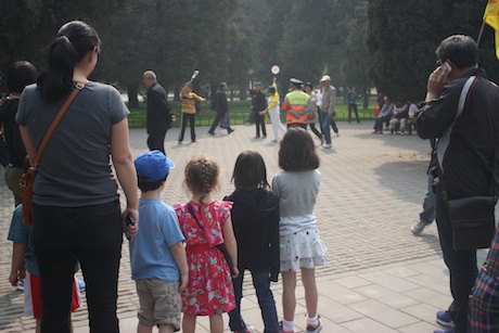 The kids watching the Chinese playing a Tai Chi game with a paddle and ball - the partners move the ball from person-to-person without letting it drop. Quite graceful!