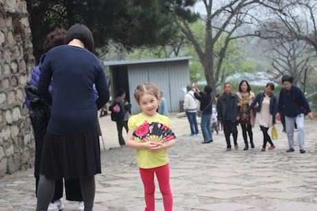 Maile Girl posing with her new fan on the  walk up to the Wall...