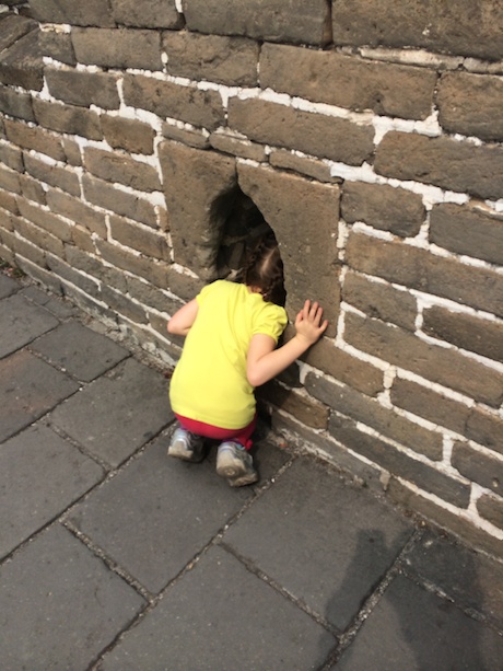 Maile getting her first taste of the wall - these holes (used to pour hot oil on the enemies) were just the right height!