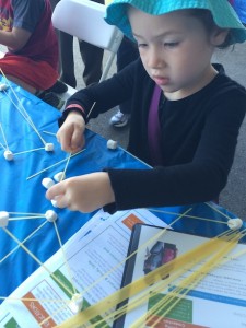 Maile girl hard at work building a structure out of spaghetti and (once again) mini marshmallows...