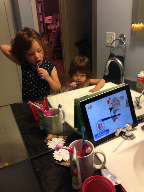 Sisters brush teeth together