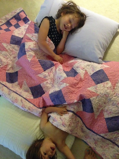 Sisters make a new bed in mommy and daddy's room and pretend to have a sleepover...