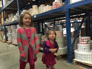 Maile and Lauren on the factory floor taking it all in and contemplating where to store all their new stickers...