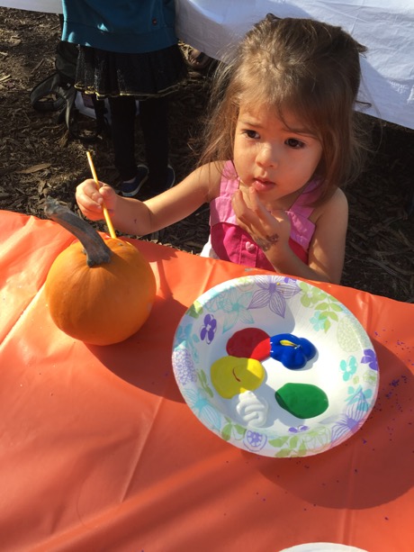 Lauren putting some good thought into painting her pumpkin...
