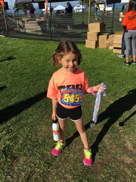 At the finish, Maile was quite pleased to have collected a medal...