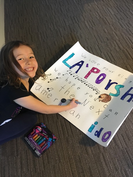 Putting the finishing touches on her sign for La'Porsha with glitter glue...