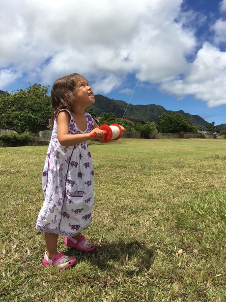 Quite proud that she her kite way up high!