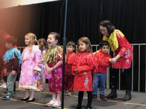 Close-up of Lauren on stage performing with her class...